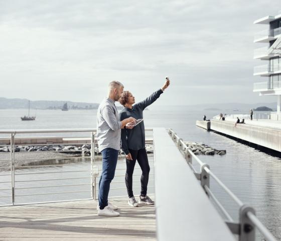 A woman and man standing on a pier 
