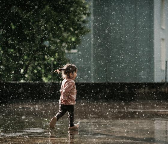 Toddler playing in the rain
