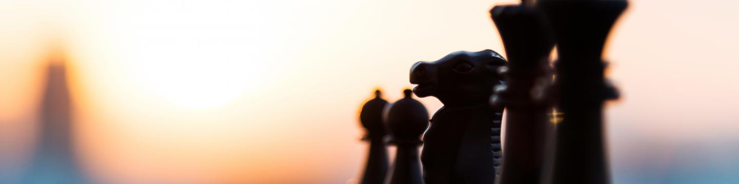 Black chess figures in a line