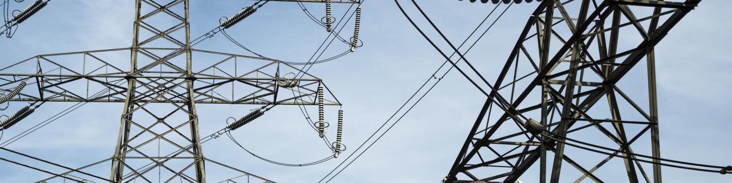 Electricity pylons against a blue sky