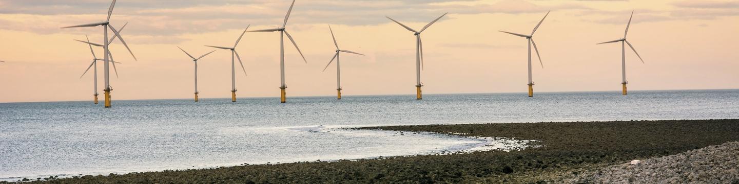 Offshore wind turbines in a sunset outside of the UK
