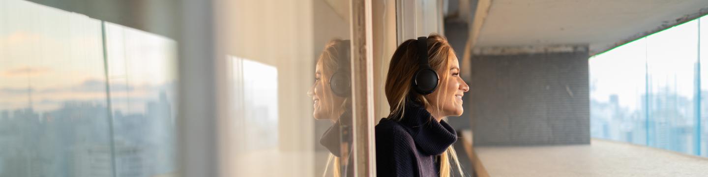 Woman listening to podcast with headphones