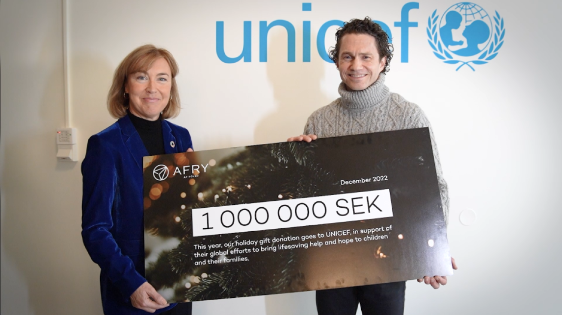 AFRY and Unicef colleagues hold giant donation cheque for charity