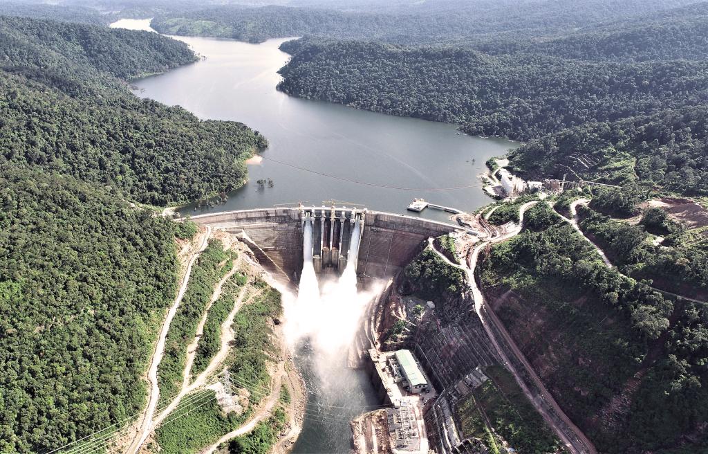 Aerial view from downstream of the Nam Theun 1 RCC Dam, power plant, and reservoir