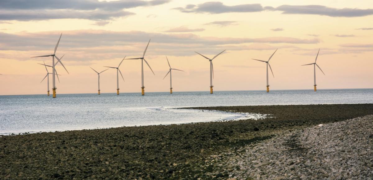 Offshore wind turbines in a sunset outside of the UK