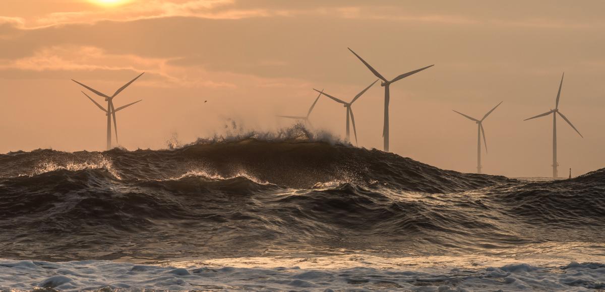 Wind turbines at sunrise off the North East coast of UK