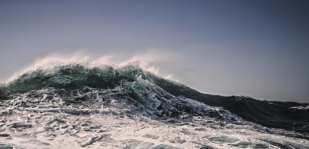 Wind blown crest of an ocean wave