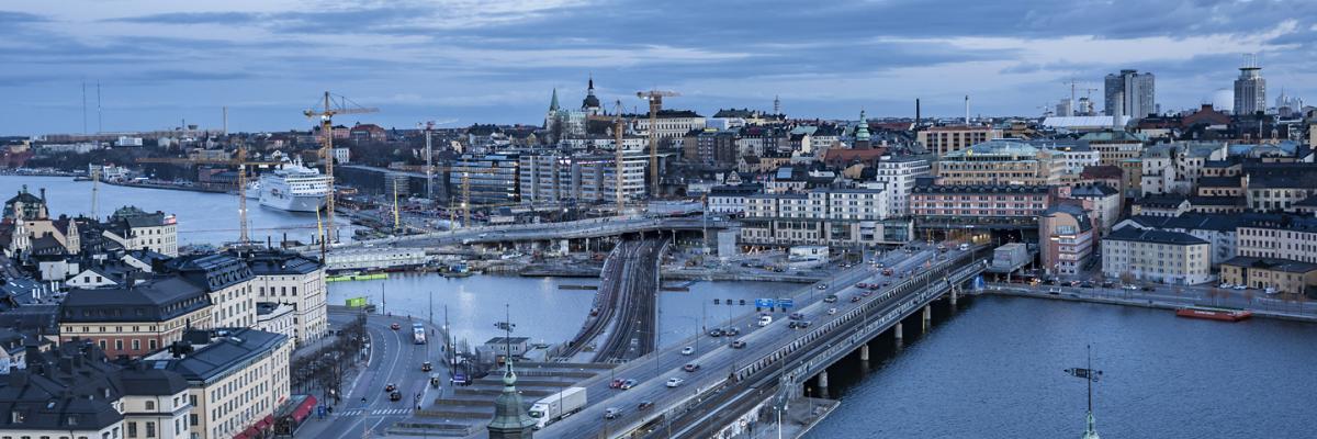 View over the city of Stockholm: buildings, water, bridges and tower cranes