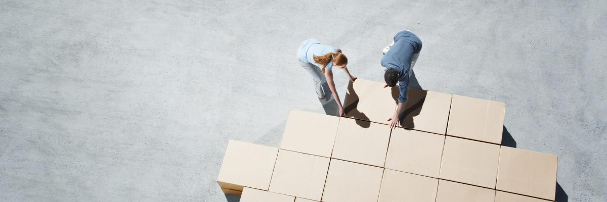 People stacking boxes in a business solution oriented way