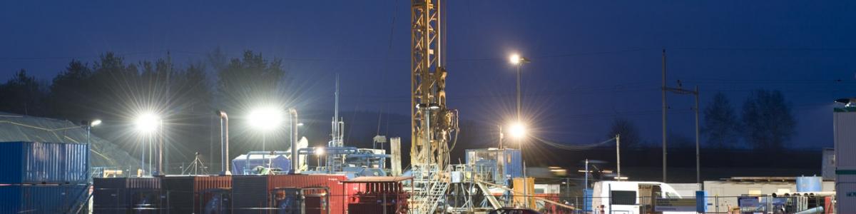 A groundwater drilling rig at night