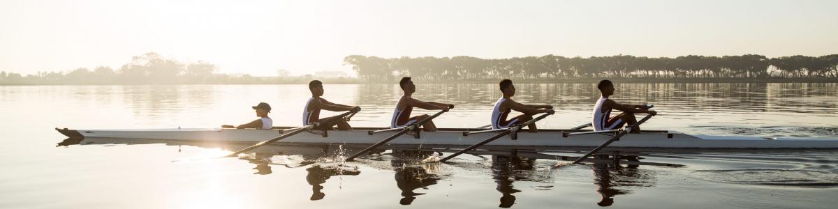 Team rowing together on water