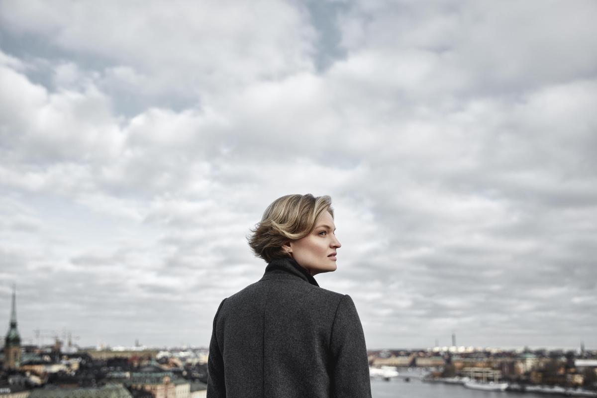 Woman standing in front of Stockholm skyline 