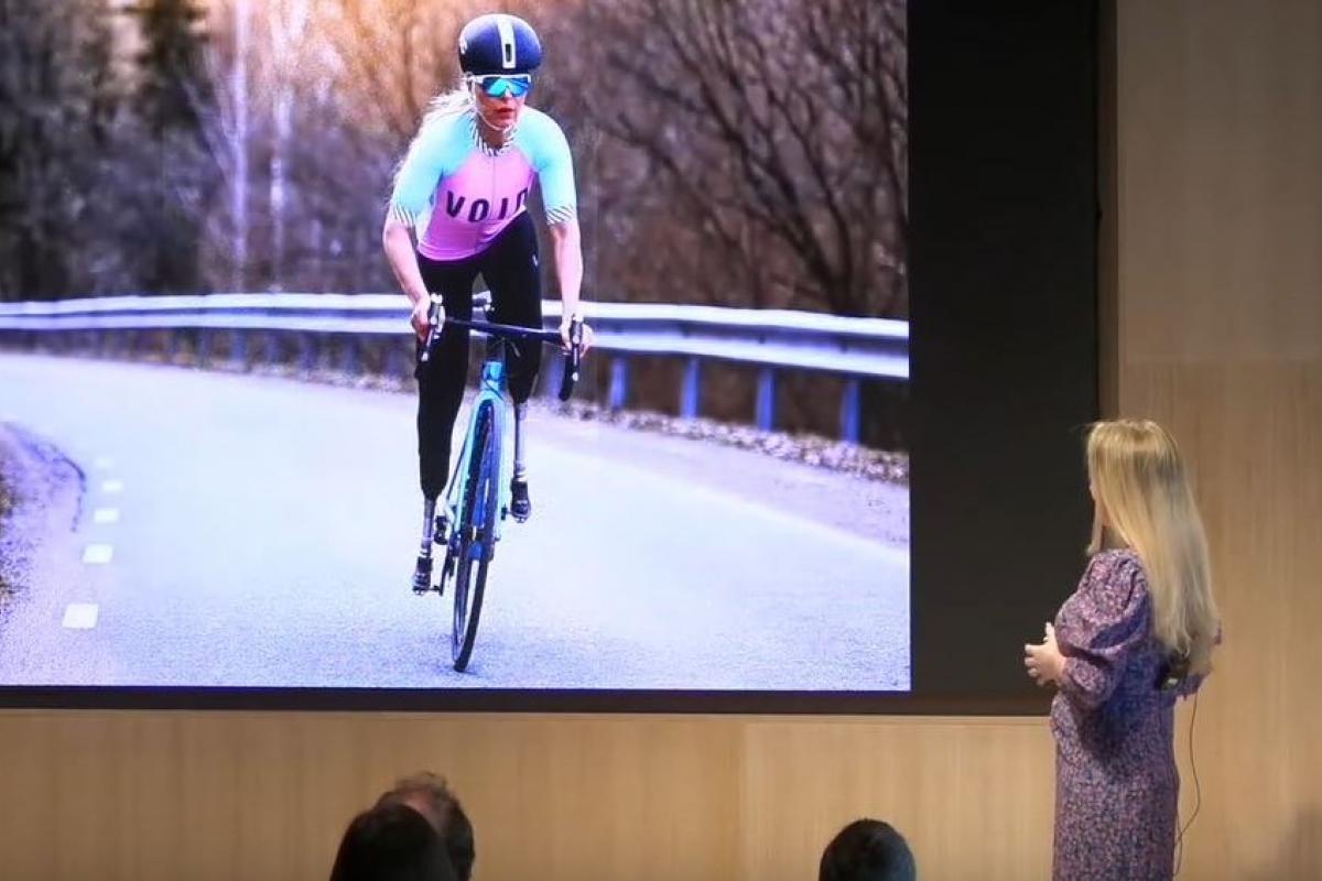 Photo of professional woman cyclist projected onto screen