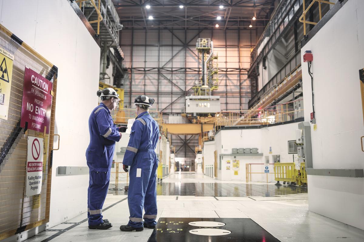Engineers consulting in nuclear charging hall