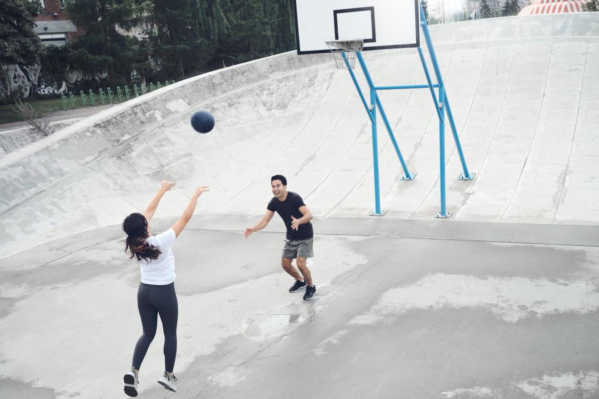 Two people playing basketball