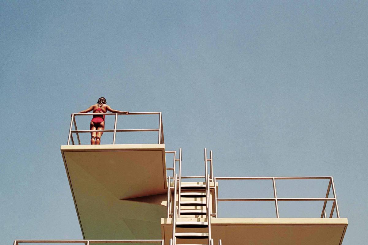 Person contemplating to jump from a diving platform