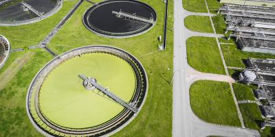 Sewage farm. Static aerial photo looking down onto the clarifying tanks and green grass.