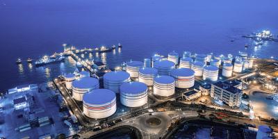 Onshore LNG storage tank facility in evening blue light