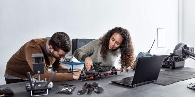 Woman and man looking at robotics