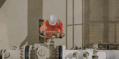Maintenance worker operating valve