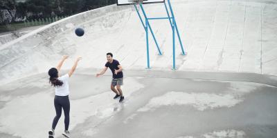 Two people playing basketball
