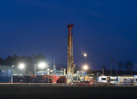 A groundwater drilling rig at night