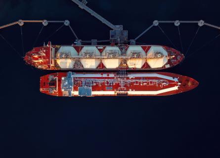 Ariel view of two red ships docked 
