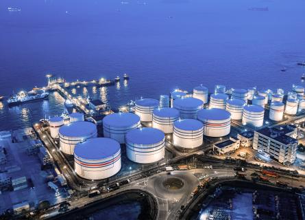 Onshore LNG storage tank facility in evening blue light
