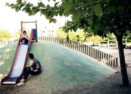 father and children at a playground