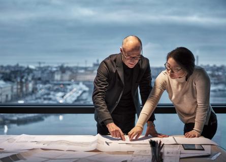 Woman and man looking over plans for life cycle assessment