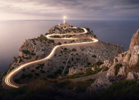 Lighthouse with lights shining on road