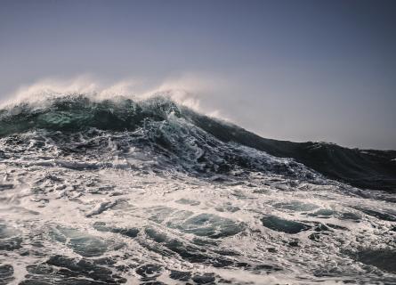 Wind blown crest of an ocean wave