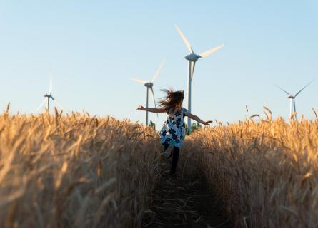 A girl running through a wheat field