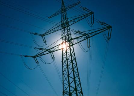 Electricity pilon against a blue sky