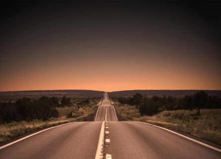Bumpy road leading towards sunset
