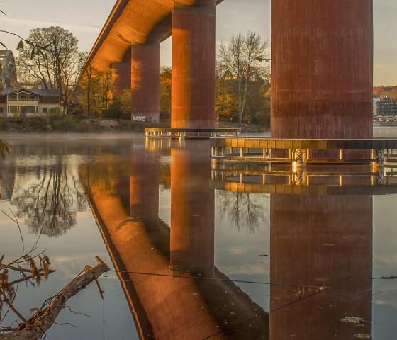 Reflection of a bridge on calm water