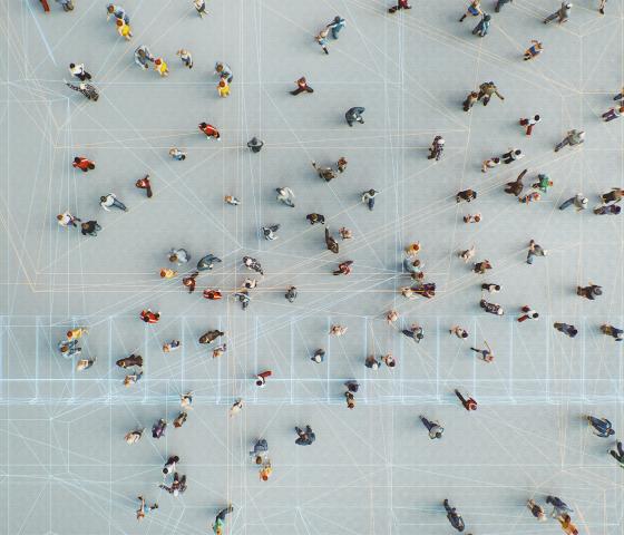 Drone perspective of a group of people connected through digital networks