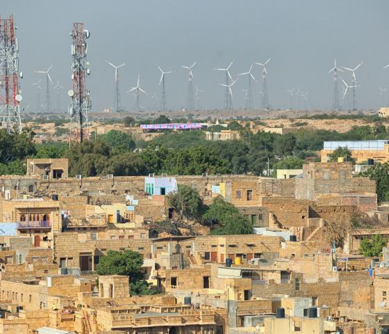 Streets with cell towers and wind power generators in the background