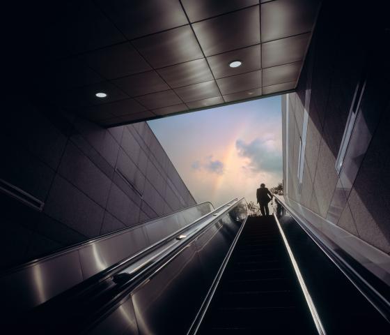 looking at the sky above from escalator in subway ascent