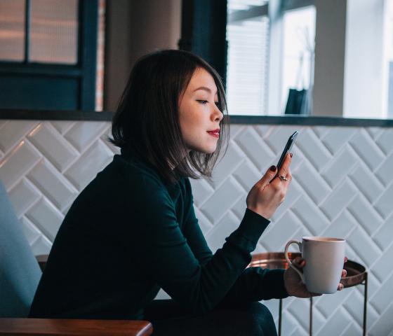 woman with coffee in office