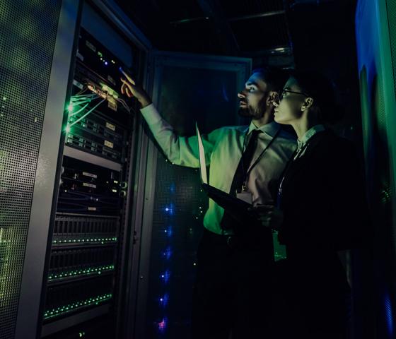 Two people inspecting artificial intelligence server