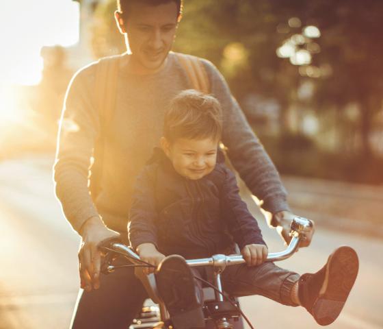 Man rides bike with child