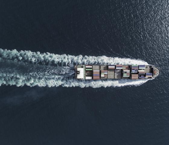 a ship transporting containers over the sea