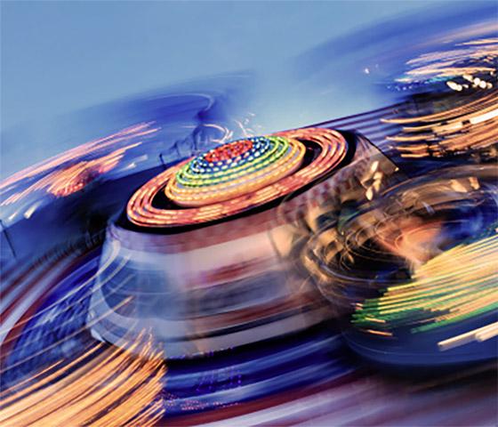 Blurry view of an amusement park ride spinning in circular motion