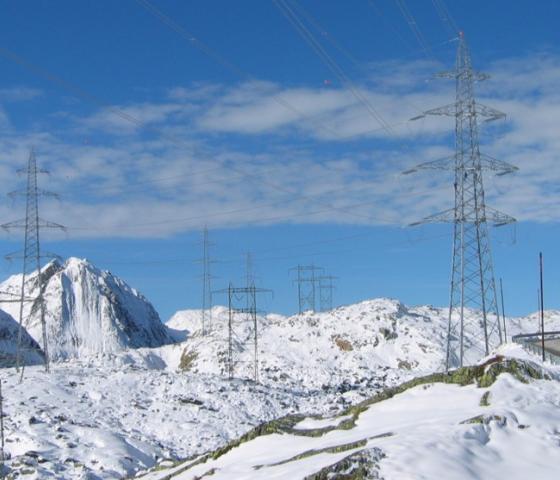 High voltage grid running over snowy alps