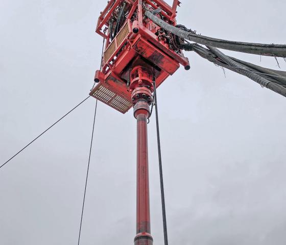 Skyward view of red drilling machine